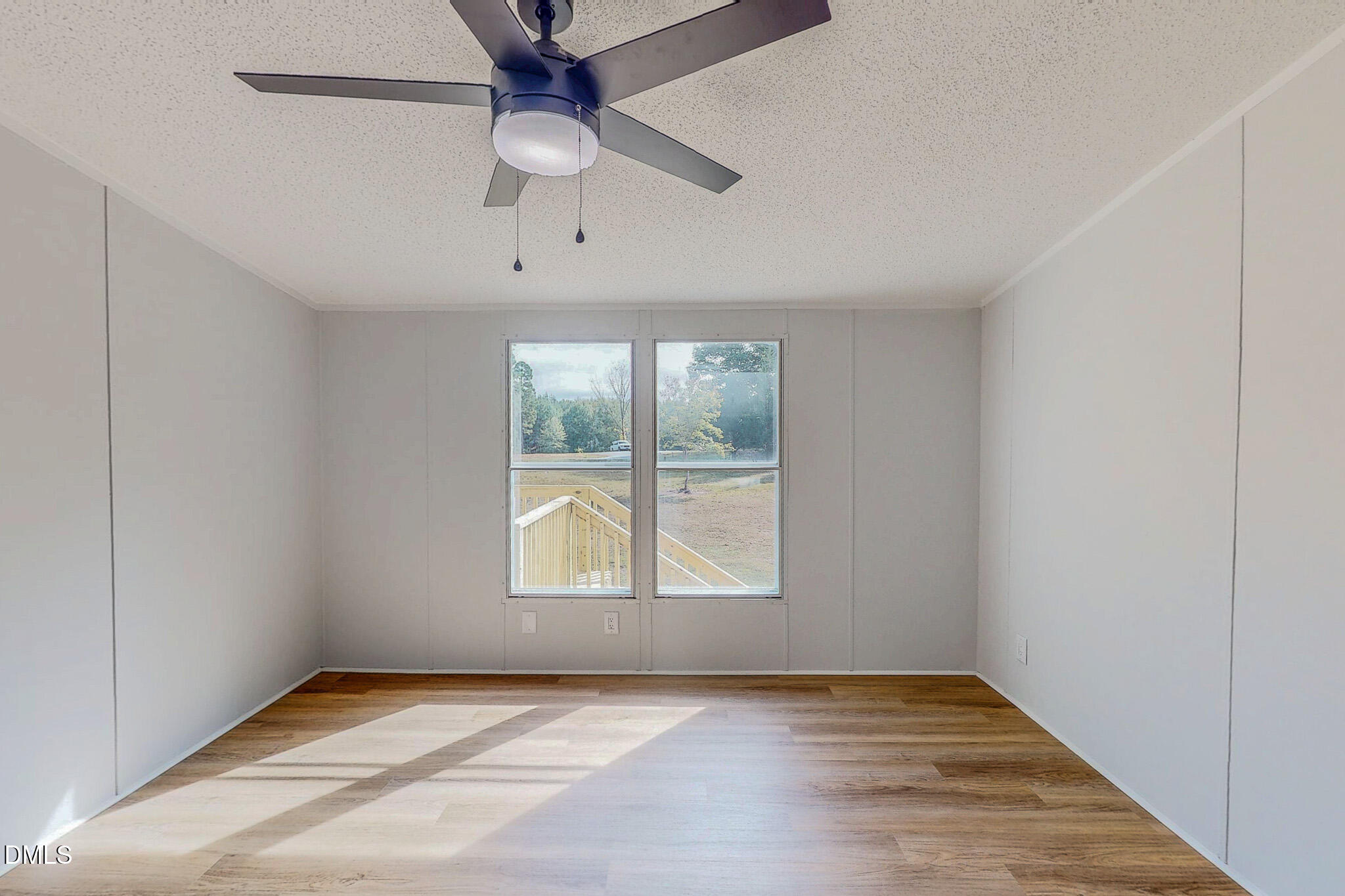 1469 Mollie Mooney Road Roxboro, NC 27574 - Photo 31 of 52 an empty room with chandelier fan and windows