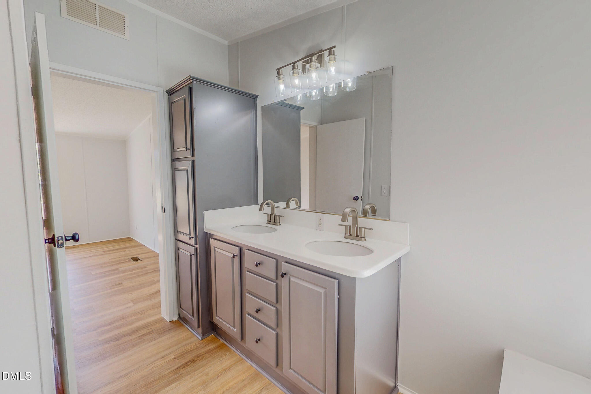 1469 Mollie Mooney Road Roxboro, NC 27574 - Photo 35 of 52 a bathroom with a double vanity sink and a mirror