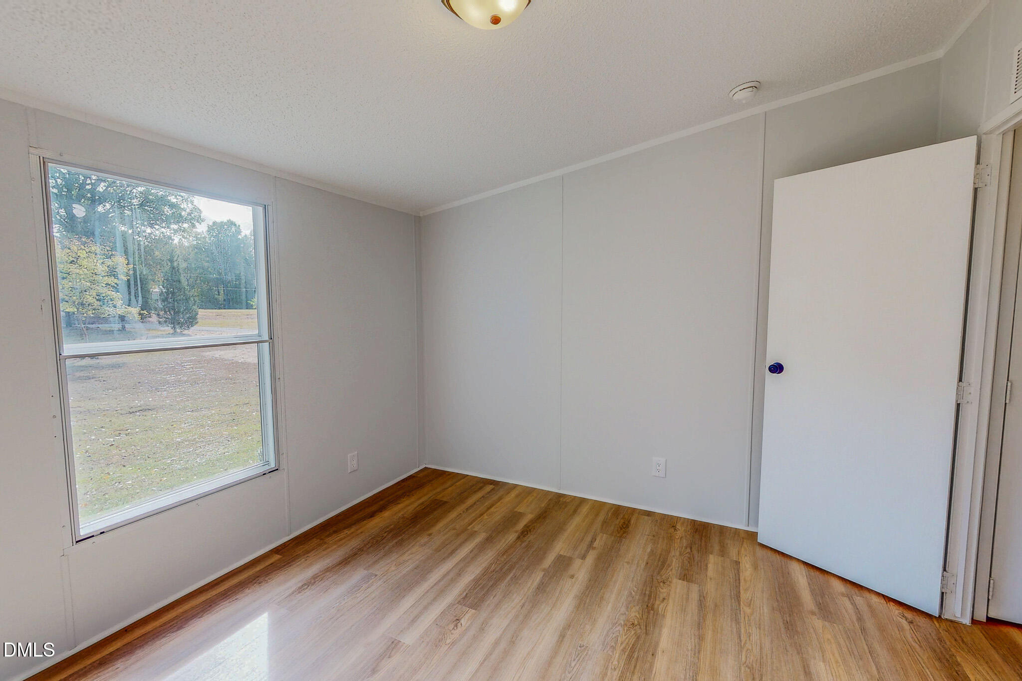 1469 Mollie Mooney Road Roxboro, NC 27574 - Photo 39 of 52 a view of empty room with wooden floor and fan