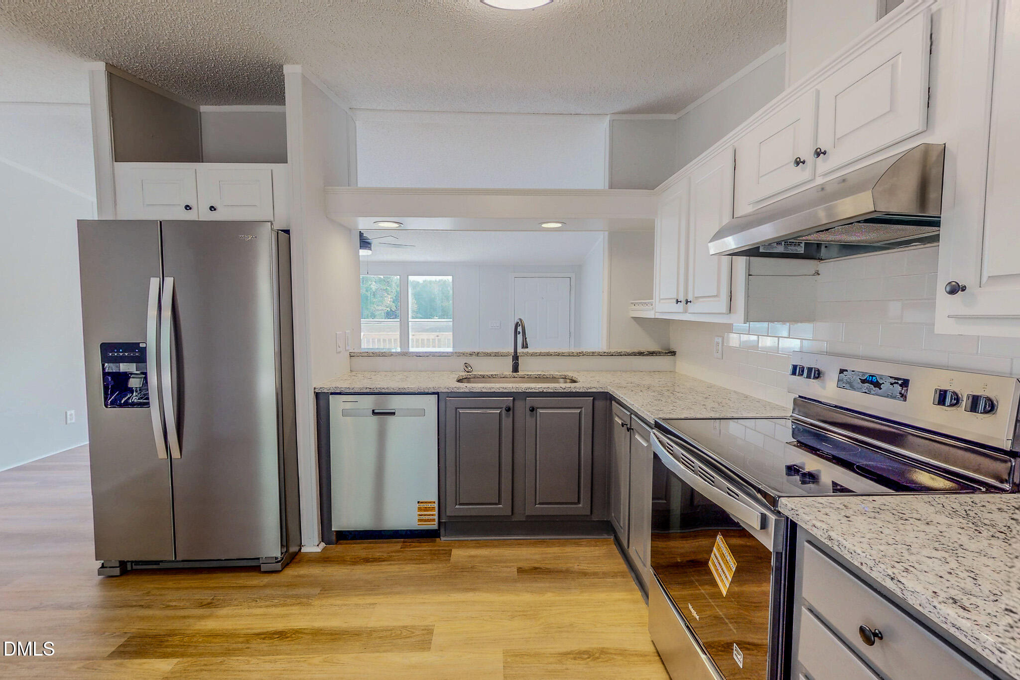1469 Mollie Mooney Road Roxboro, NC 27574 - Photo 4 of 52 a kitchen with stainless steel appliances granite countertop a refrigerator sink and stove