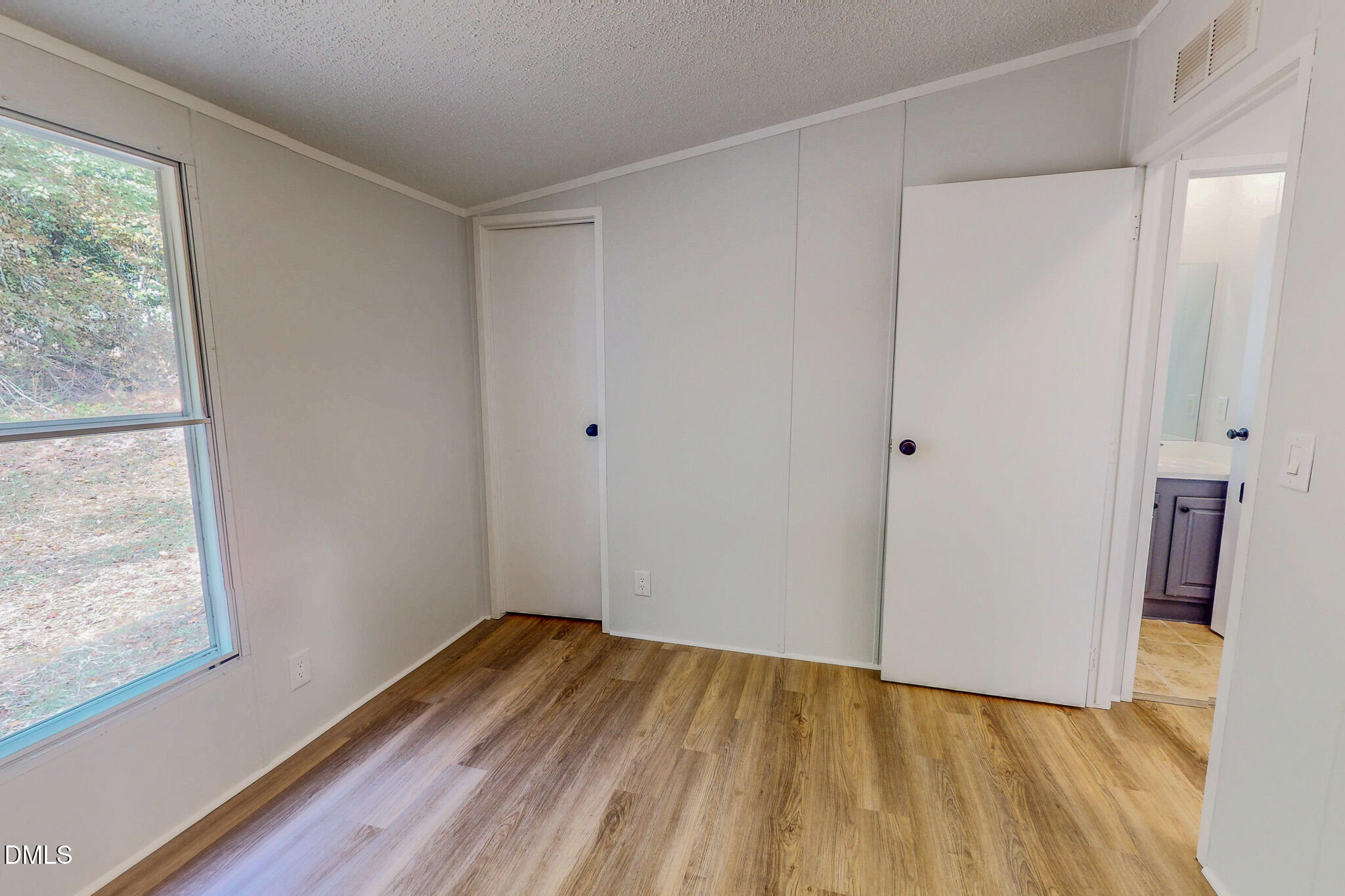 1469 Mollie Mooney Road Roxboro, NC 27574 - Photo 41 of 52 a view of empty room with wooden floor and fan