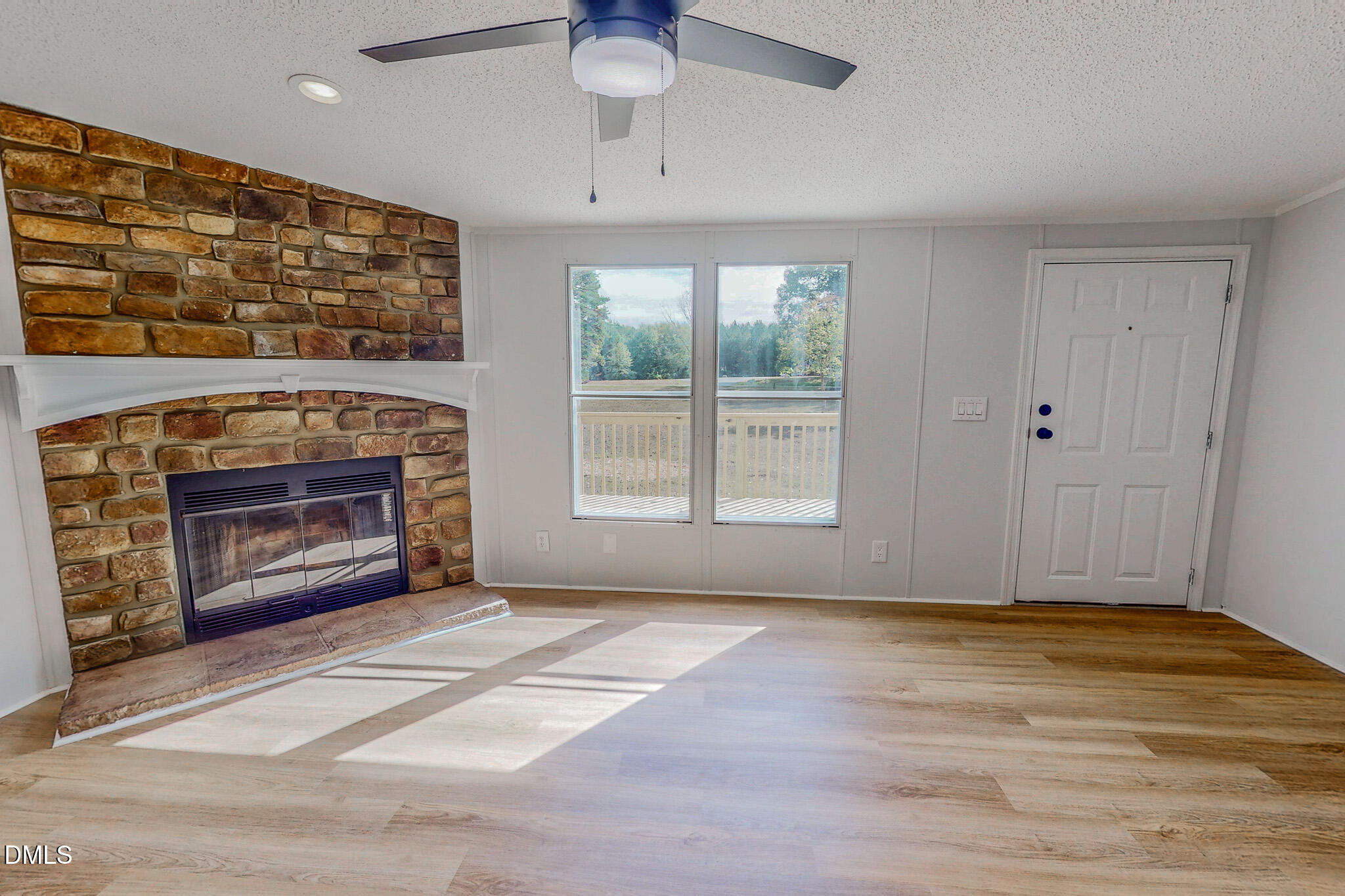 1469 Mollie Mooney Road Roxboro, NC 27574 - Photo 47 of 52 a view of an empty room with a fireplace and a window