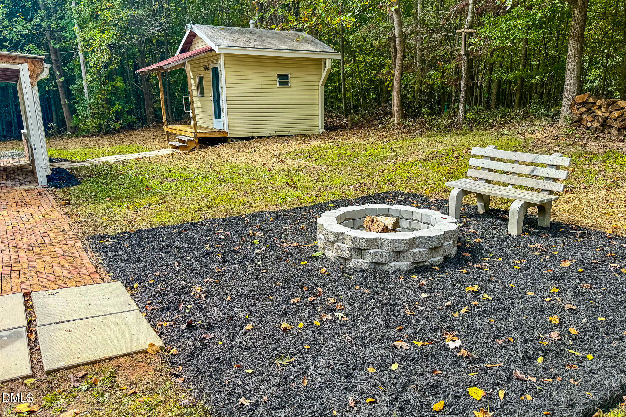 1469 Mollie Mooney Road Roxboro, NC 27574 - Photo 51 of 52 a view of a backyard with table and chairs and potted plants