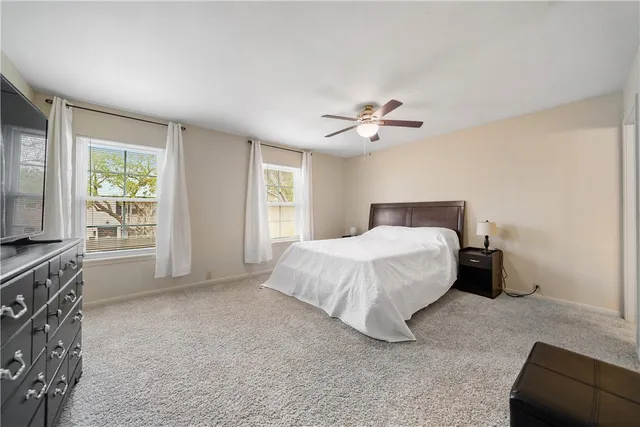 a spacious bedroom with a bed and a couch