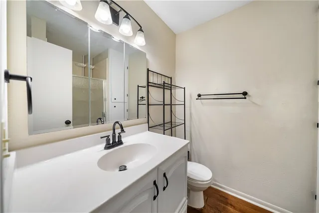 a bathroom with a sink toilet and a mirror