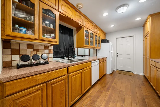 a large kitchen with stainless steel appliances granite countertop a sink and cabinets