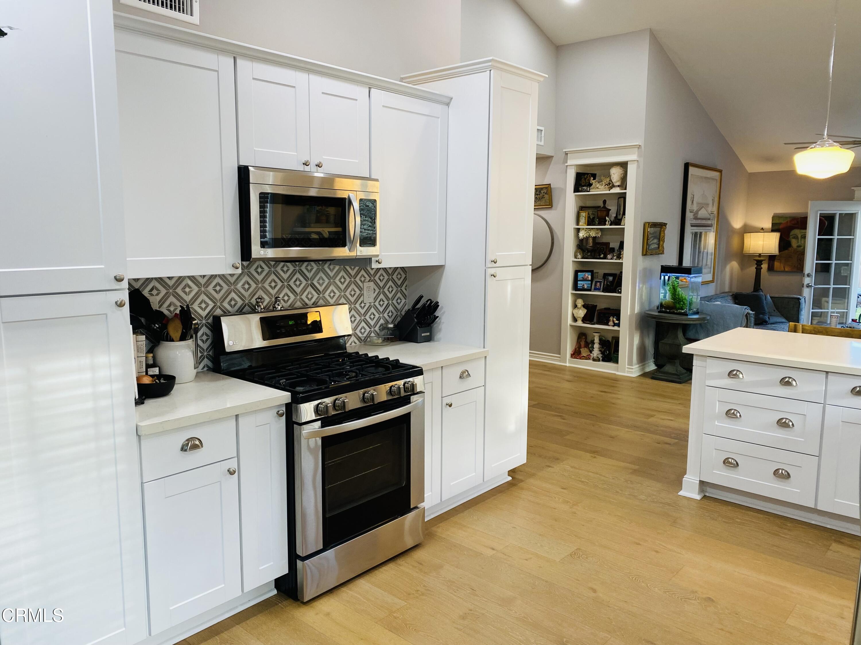9908 Cheyenne Circle Ventura, CA 93004 - Photo 8 of 19 a kitchen with stainless steel appliances white cabinets and a stove top oven