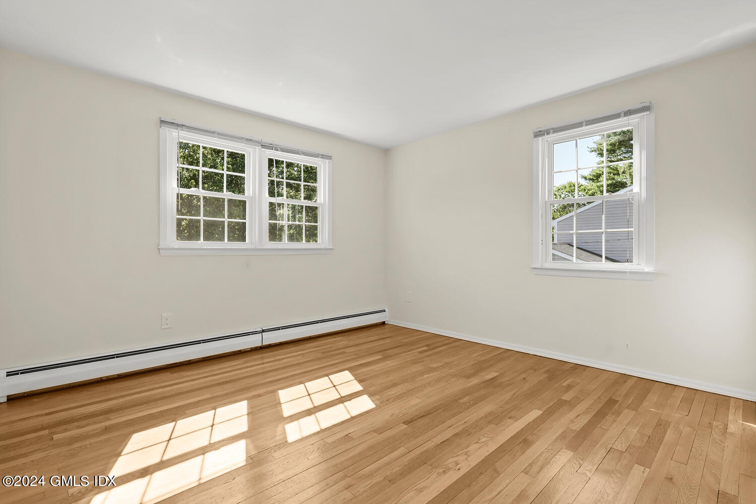 32 Rainbow Drive Riverside, CT 06878 - Photo 11 of 19 a view of an empty room with wooden floor and a window