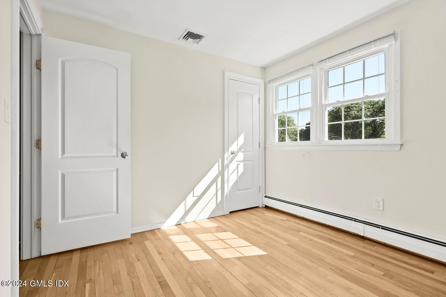 32 Rainbow Drive Riverside, CT 06878 - Photo 12 of 19 an empty room with wooden floor and windows