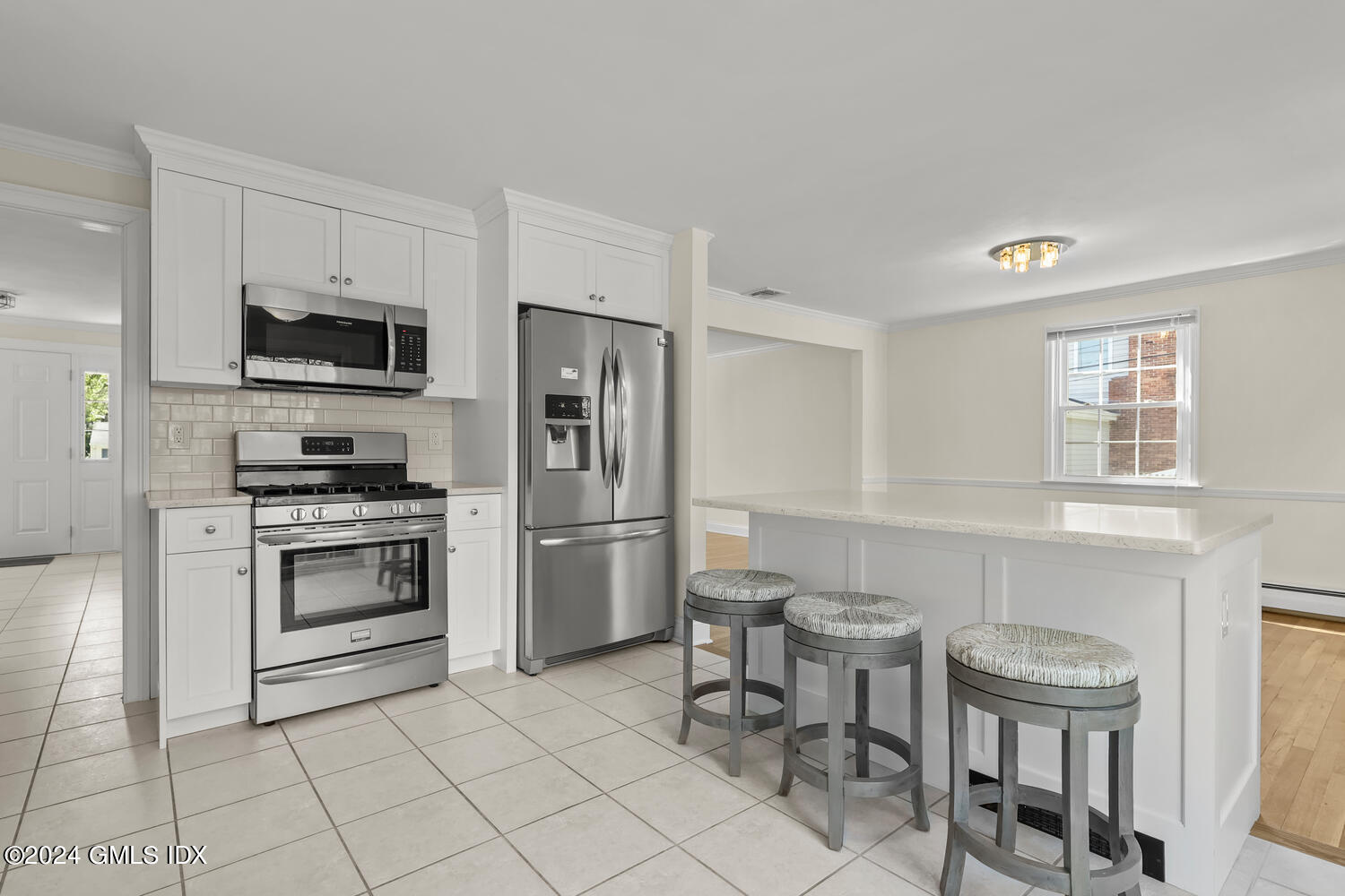 32 Rainbow Drive Riverside, CT 06878 - Photo 3 of 19 a kitchen with stainless steel appliances a stove a sink and a refrigerator