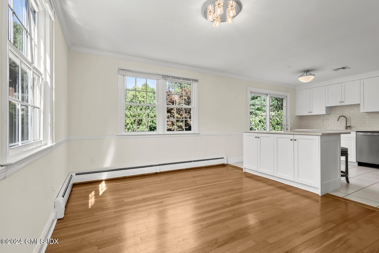 32 Rainbow Drive Riverside, CT 06878 - Photo 5 of 19 a view of an empty room with a window and wooden floor