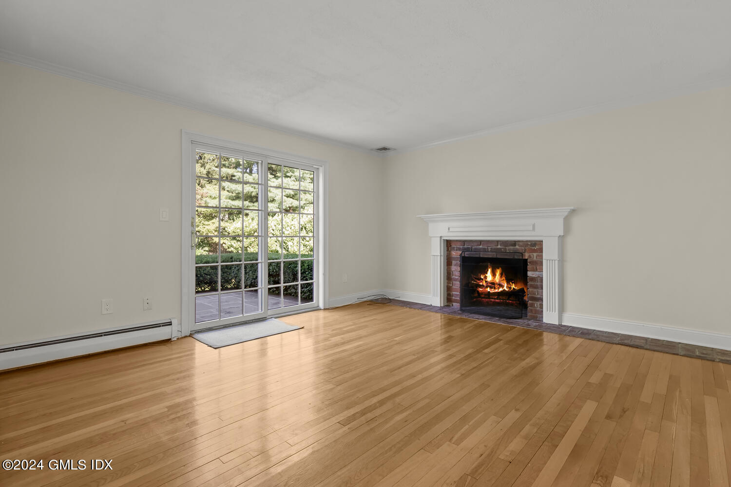 32 Rainbow Drive Riverside, CT 06878 - Photo 6 of 19 an empty room with wooden floor fireplace and windows