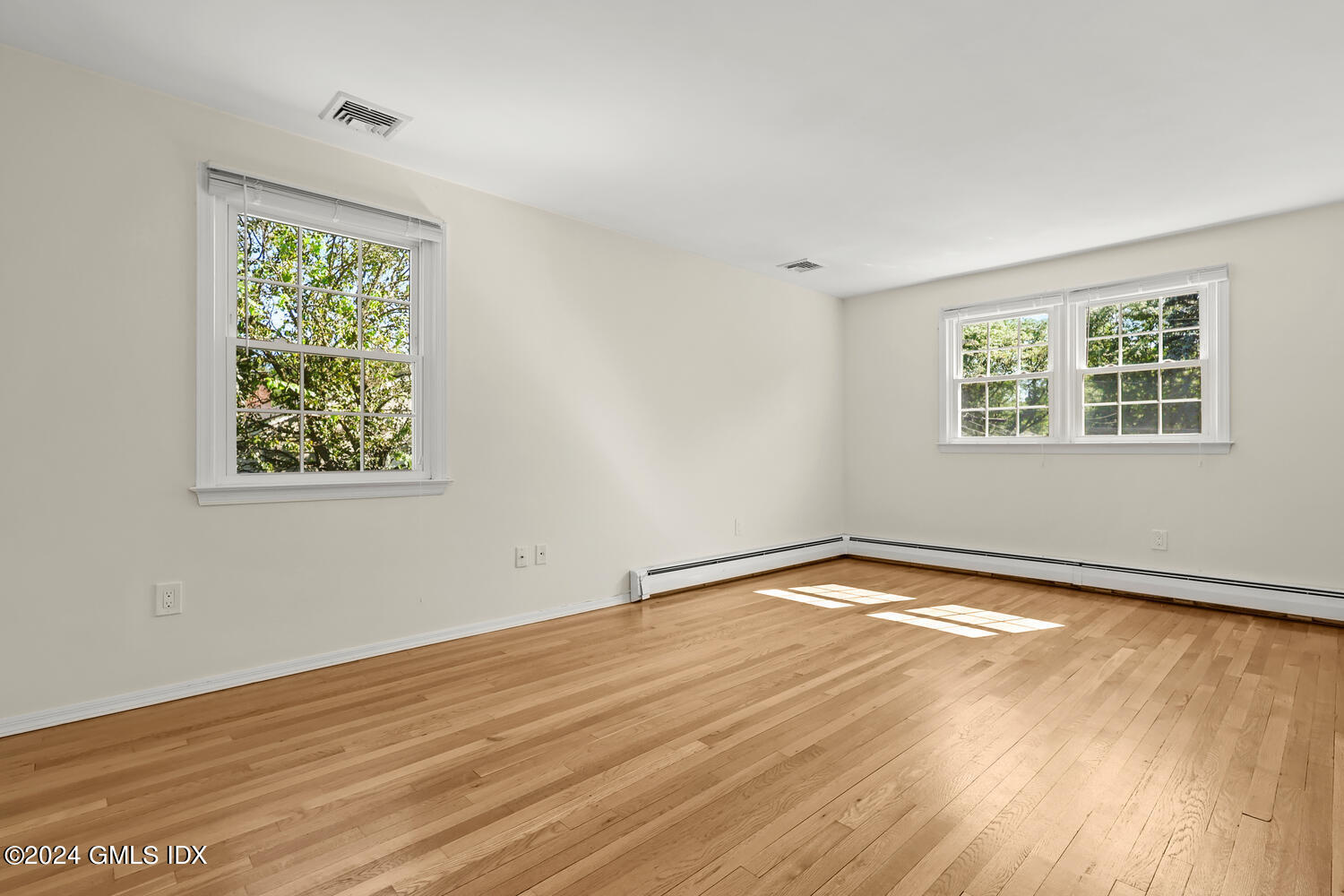 32 Rainbow Drive Riverside, CT 06878 - Photo 8 of 19 a view of an empty room with wooden floor and a window
