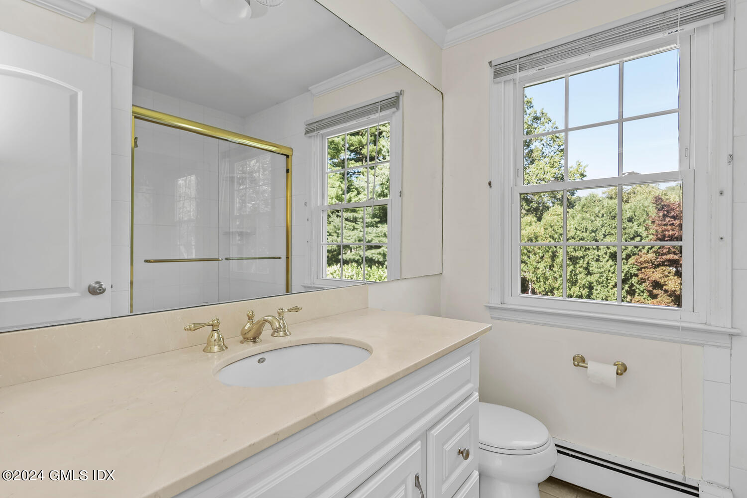 32 Rainbow Drive Riverside, CT 06878 - Photo 9 of 19 a bathroom with a granite countertop sink a toilet and a window