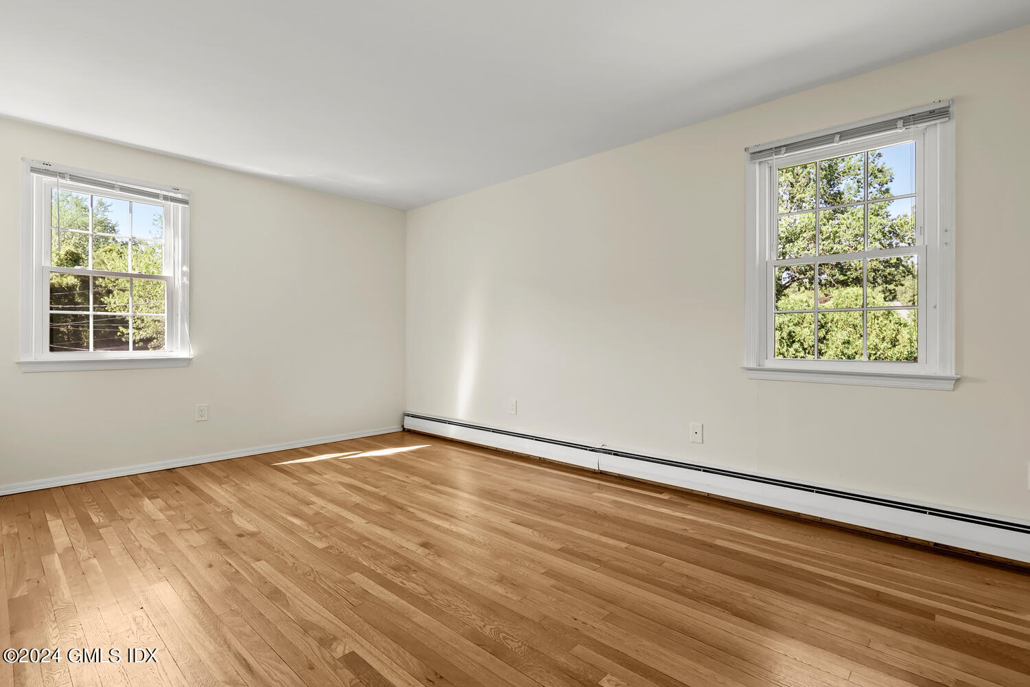 32 Rainbow Drive Riverside, CT 06878 - Photo 10 of 19 a view of an empty room with wooden floor and a window