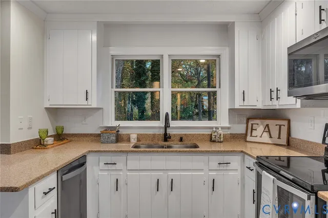 a kitchen with granite countertop a sink and a window