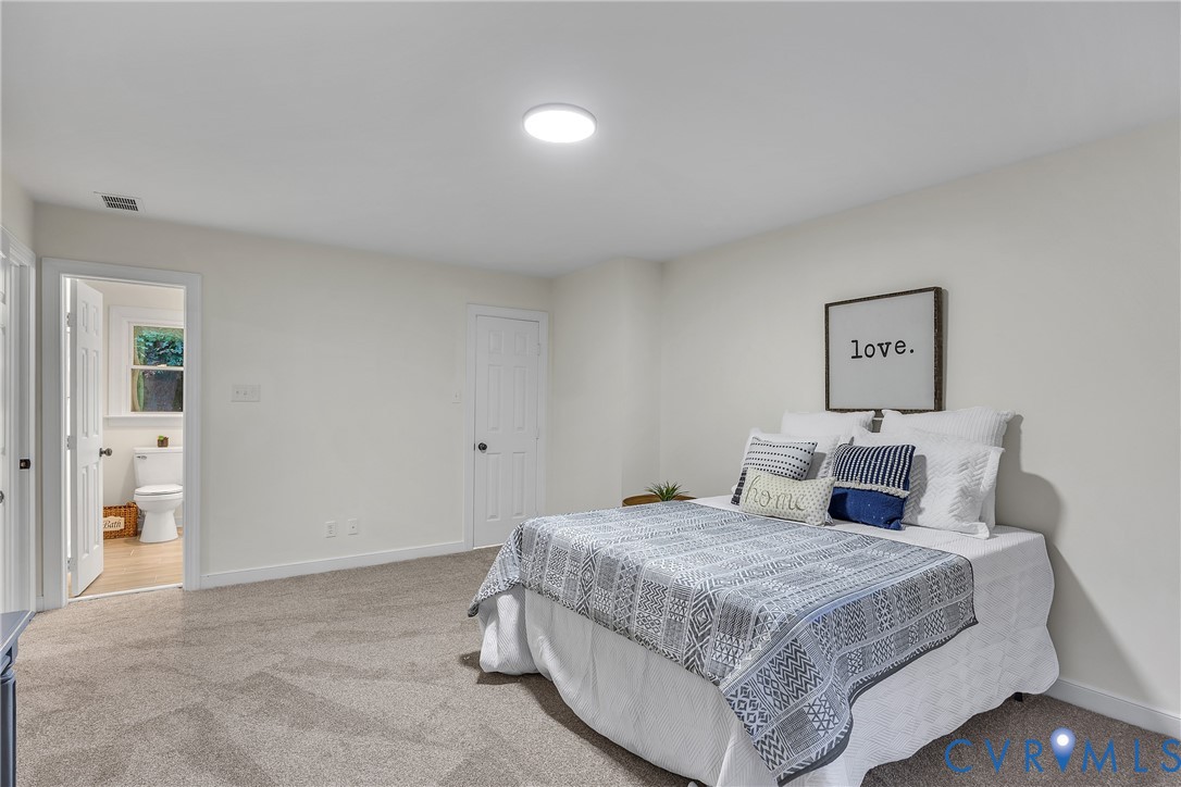 2604 Whispering Oaks Terrace Midlothian, VA 23112 - Photo 19 of 35 Bedroom with light carpet and ensuite bath