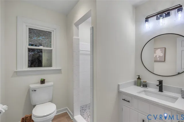 a bathroom with a toilet a sink and mirror