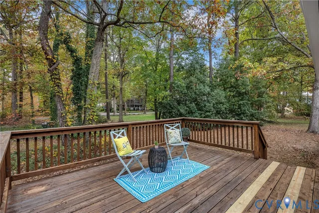 a view of a roof deck with wooden floor and outdoor seating