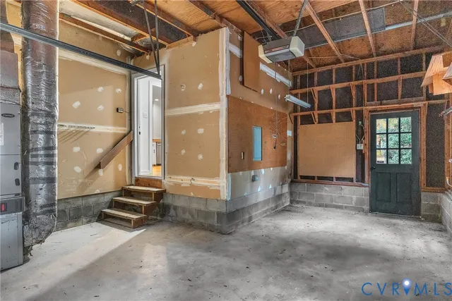 a view of an empty room with wooden floor and windows