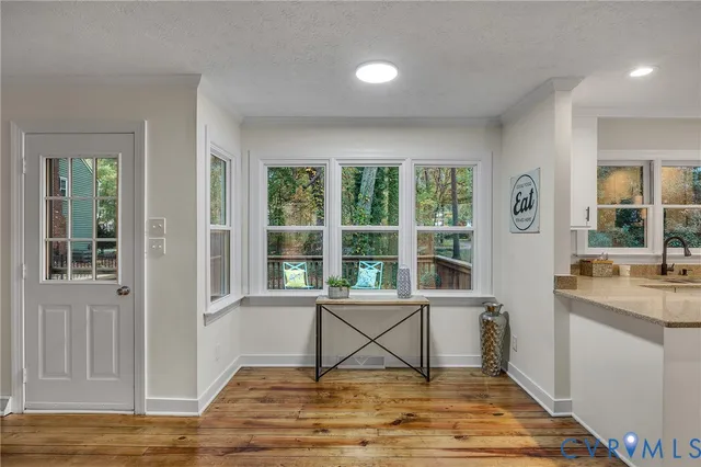 a view of a livingroom with wooden floor and a window
