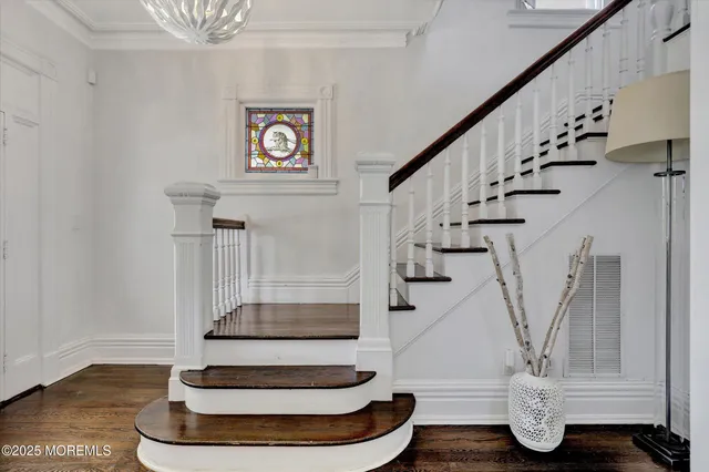 a living room with furniture floor to ceiling window and a flat screen tv