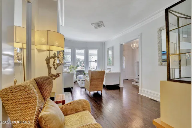 a living room with furniture or couch and a chandelier