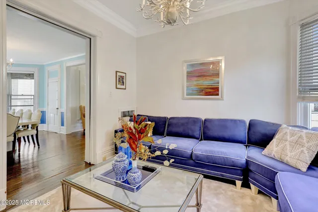 a kitchen with stainless steel appliances a sink a stove a refrigerator cabinets and living room view