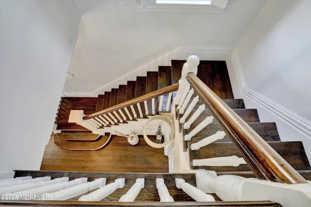 a bedroom with a bed and a flat tv screen on dresser