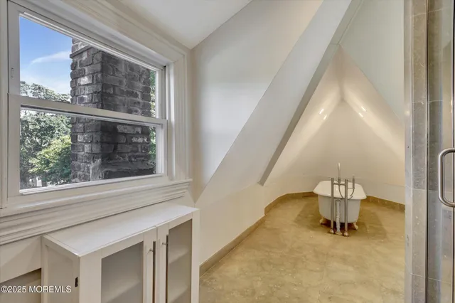 an aerial view of a city with lots of residential buildings ocean and mountain view in back