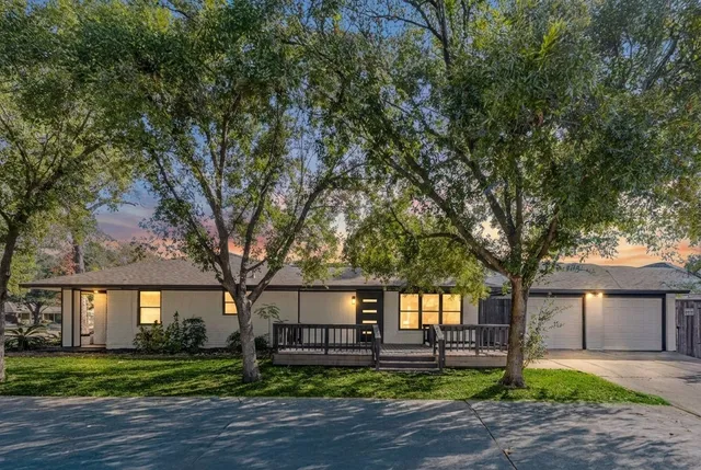 a front view of a house with a garden