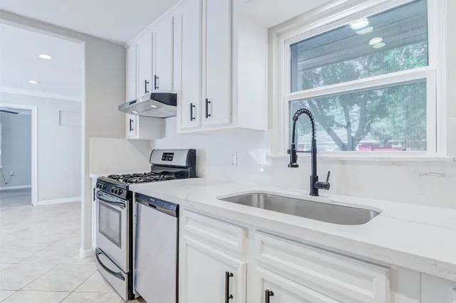 a kitchen with appliances cabinets and a sink