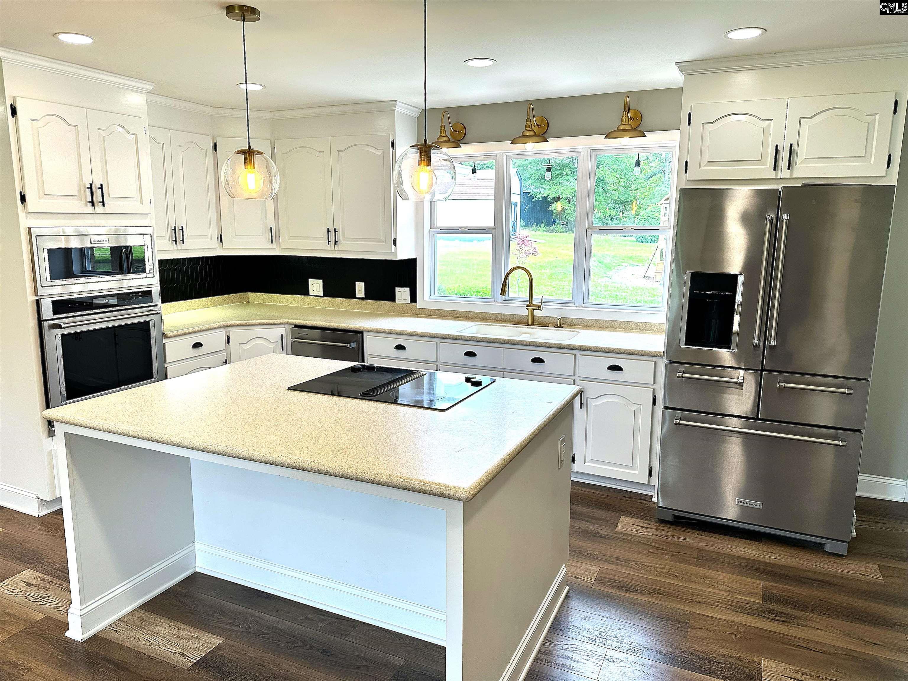535 Sandbar Road Chapin, SC 29036 - Photo 9 of 23 a kitchen with stainless steel appliances a refrigerator sink and stove