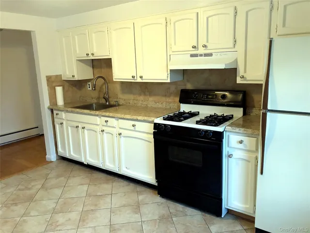 a kitchen with stainless steel appliances a stove a microwave and a refrigerator