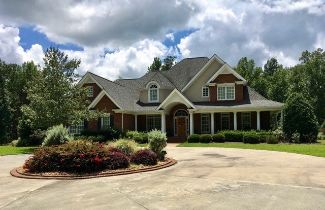 8630 East Hopewell Road Musella, GA 31066 - Photo 1 of 28 a front view of a house with a yard