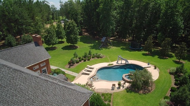 8630 East Hopewell Road Musella, GA 31066 - Photo 26 of 28 an aerial view of a house with outdoor space and trees all around
