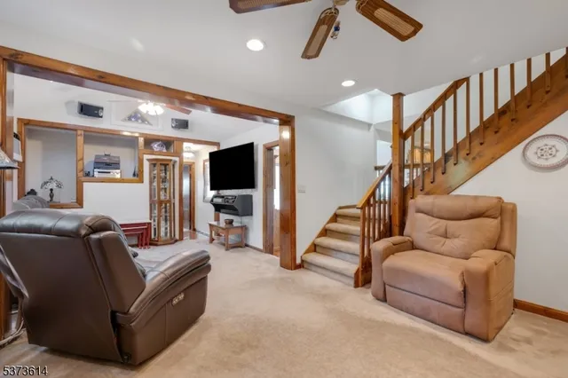 a living room with furniture and stairs