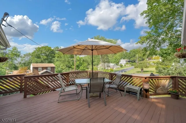 a view of a roof deck with couches chairs and wooden floor