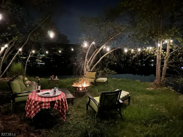 a view of a chairs and table in backyard