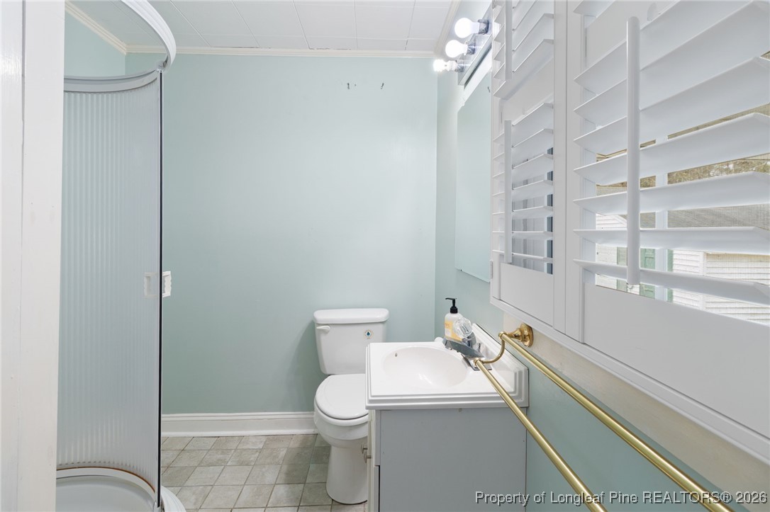 150 Old Vander Road Fayetteville, NC 28312 - Photo 13 of 38 a white toilet sitting next to a bathroom sink