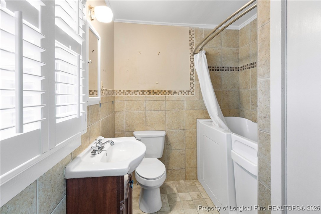 150 Old Vander Road Fayetteville, NC 28312 - Photo 15 of 38 a bathroom with a sink toilet and shower