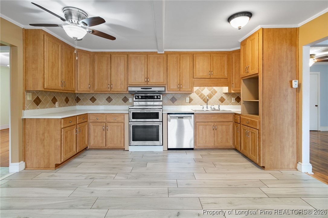 150 Old Vander Road Fayetteville, NC 28312 - Photo 6 of 38 a view of a kitchen with a sink dishwasher stove and cabinets