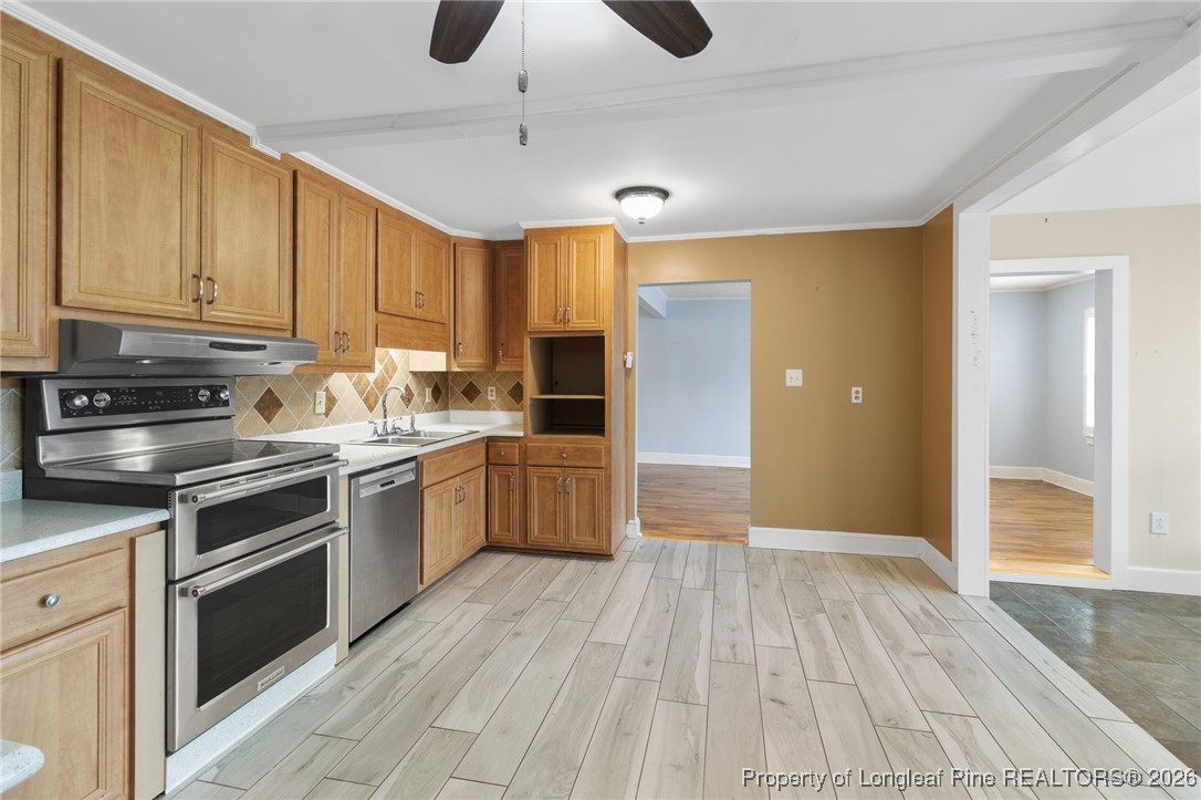 150 Old Vander Road Fayetteville, NC 28312 - Photo 7 of 38 a kitchen with a sink cabinets stainless steel appliances and a window