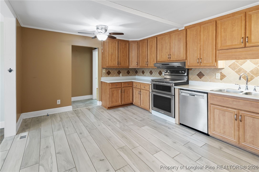 150 Old Vander Road Fayetteville, NC 28312 - Photo 8 of 38 a kitchen with a sink cabinets stainless steel appliances and a window