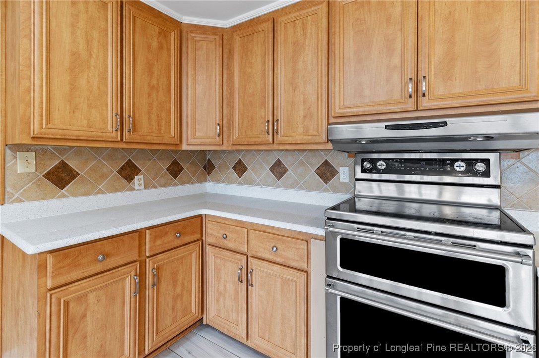 150 Old Vander Road Fayetteville, NC 28312 - Photo 10 of 38 a kitchen with granite countertop white cabinets and stainless steel appliances