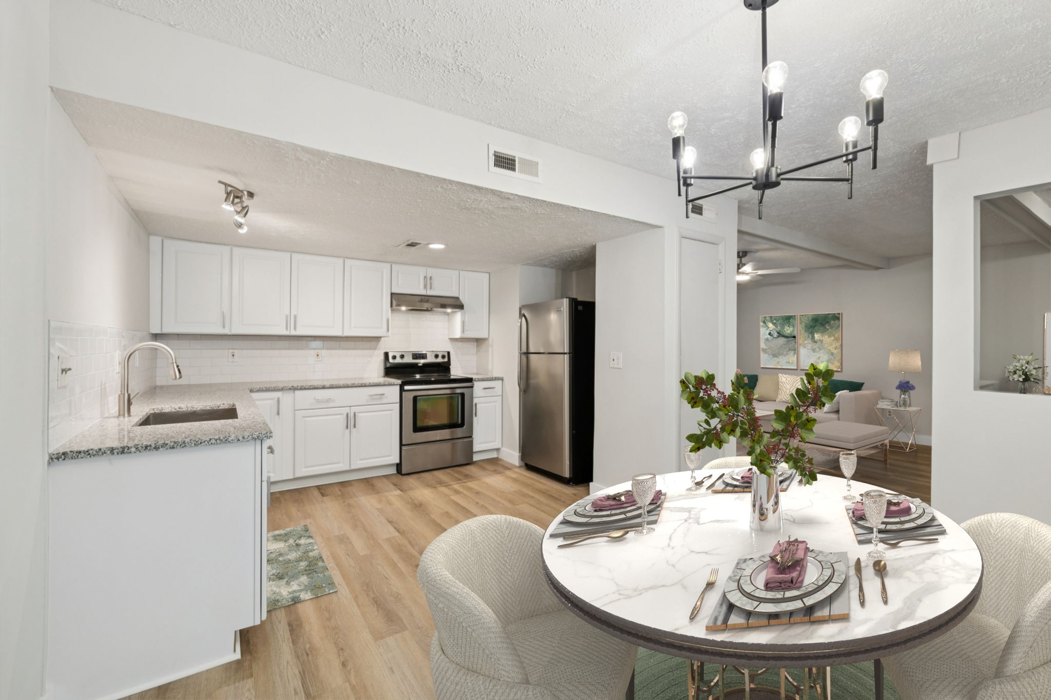 a kitchen with refrigerator a sink and chairs