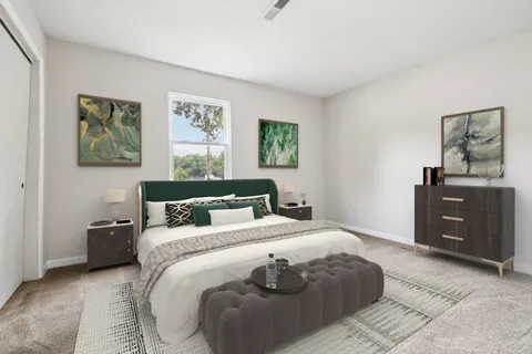 a bedroom with a bed and a cabinets