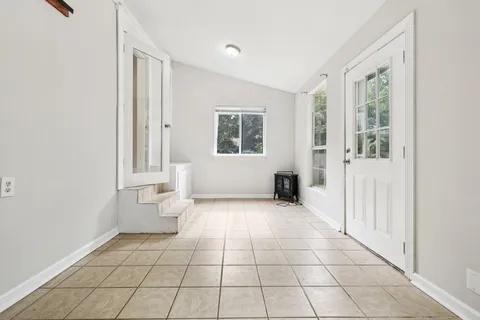 a view of a room with white walls and windows