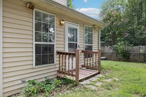 a view of a balcony with wooden floor and fence