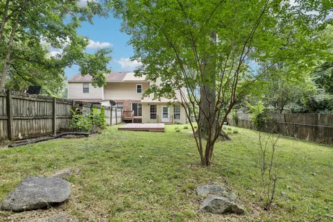 a view of a house with a yard and plants